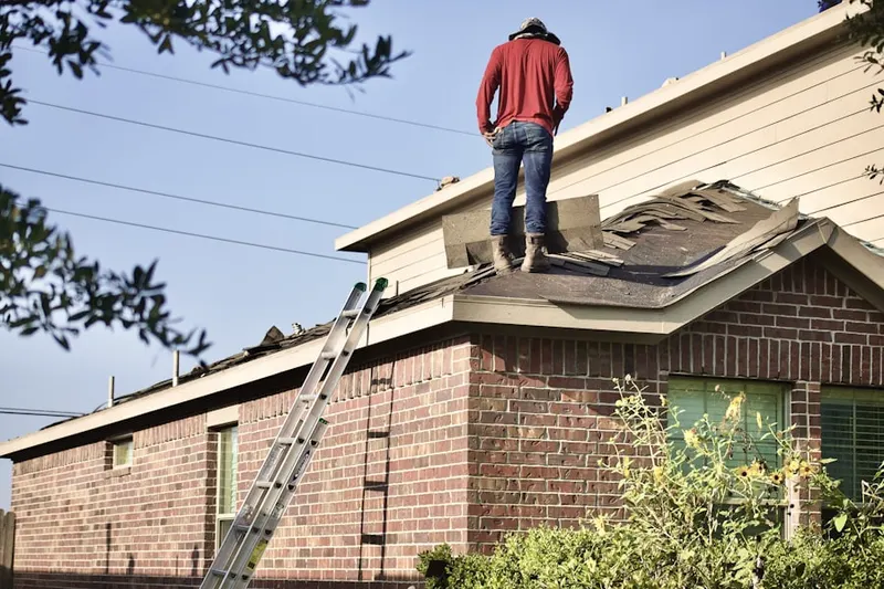 Professional roofer working on a residential roof in Buena Woods
